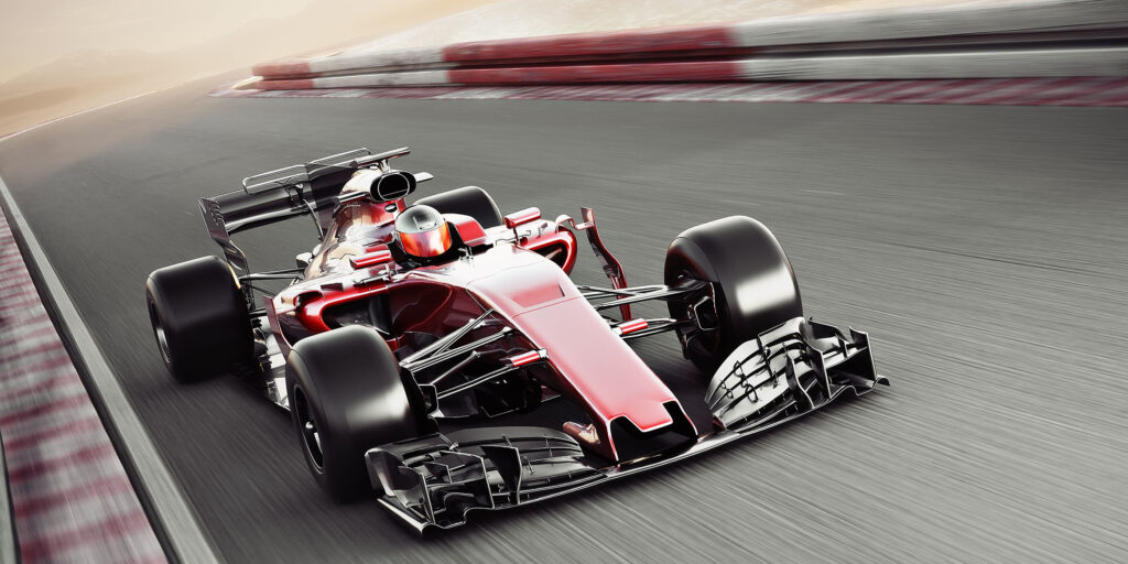 Carro de corrida em alta velocidade em uma pista de automobilismo.